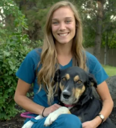 Jenna holding a dog outside